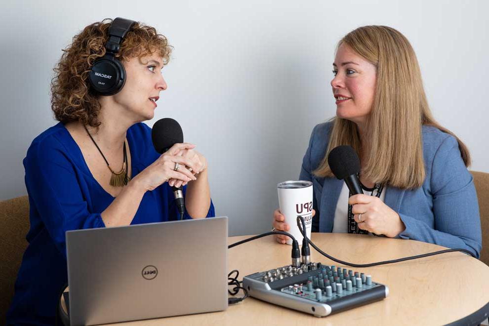 Alumni Director Amanda Stubbert (right) hosts the SPU Voices Podcast.